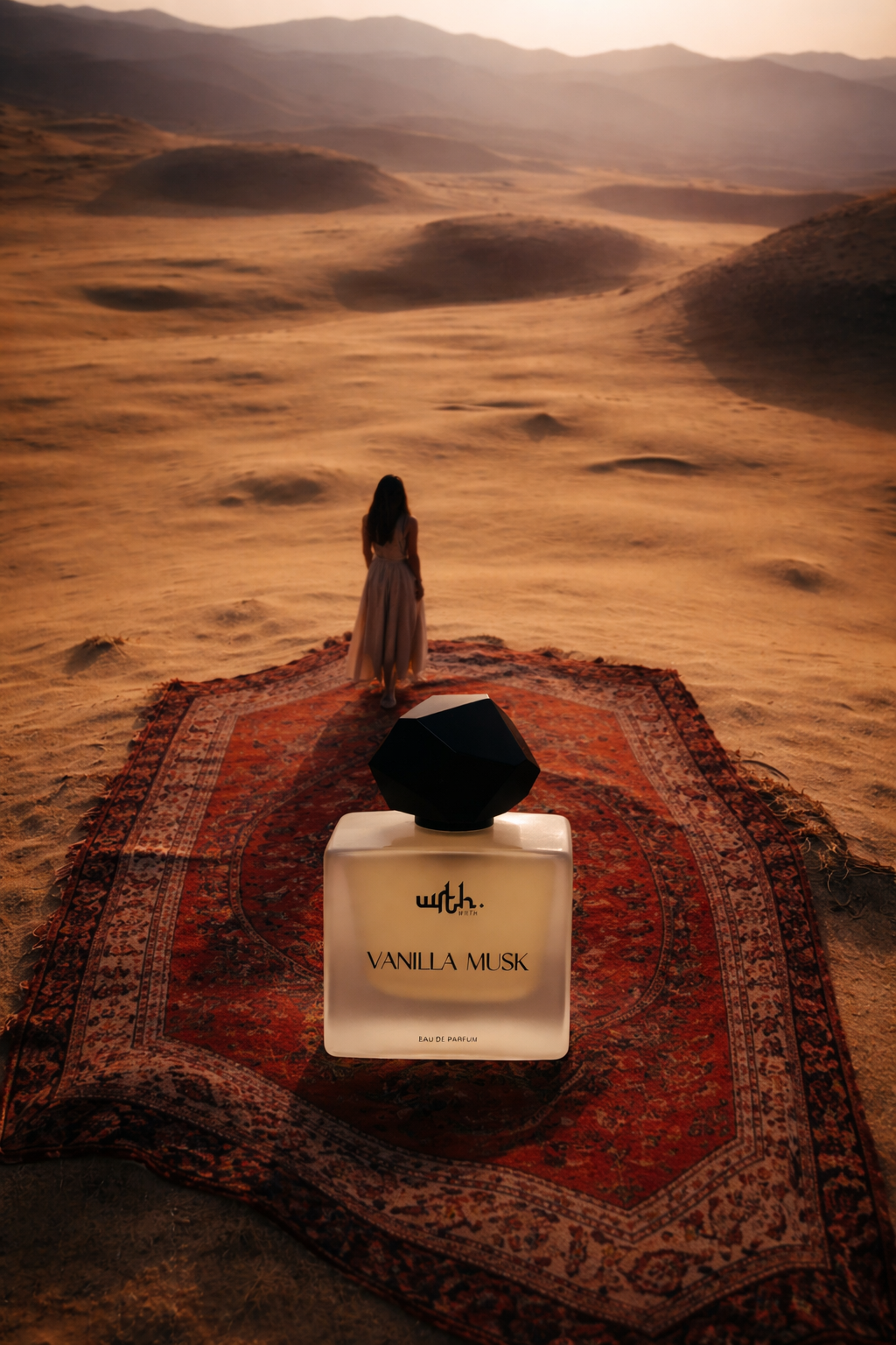 Perfume bottle labeled 'Vanilla Musk' on a rug with a desert landscape in the background