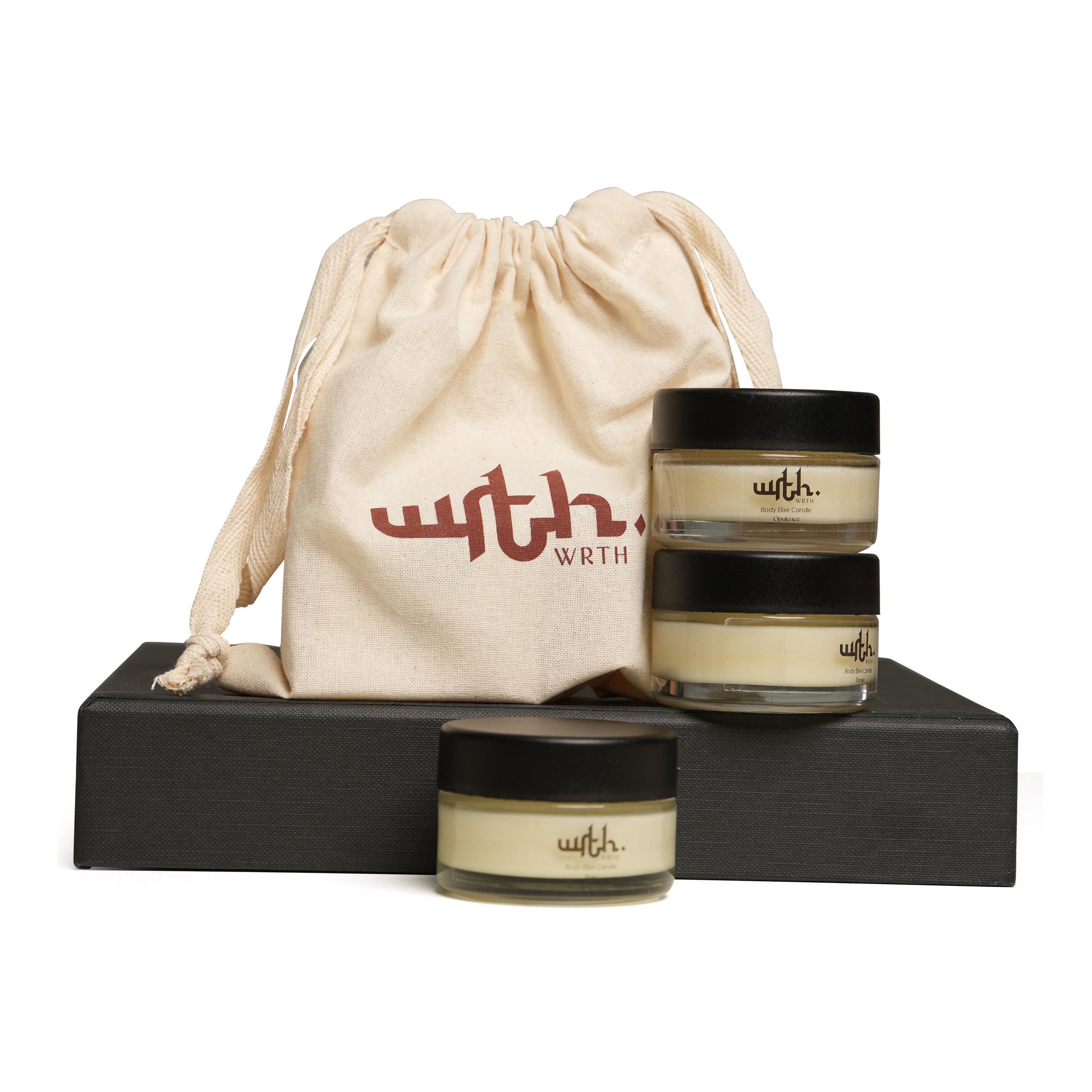 Three jars of a product with a branded drawstring bag on a black platform.