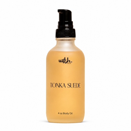 A frosted glass pump bottle of wrth  by London' Tonka Suede body oil, filled with a warm tan liquid, set against a plain white background.
