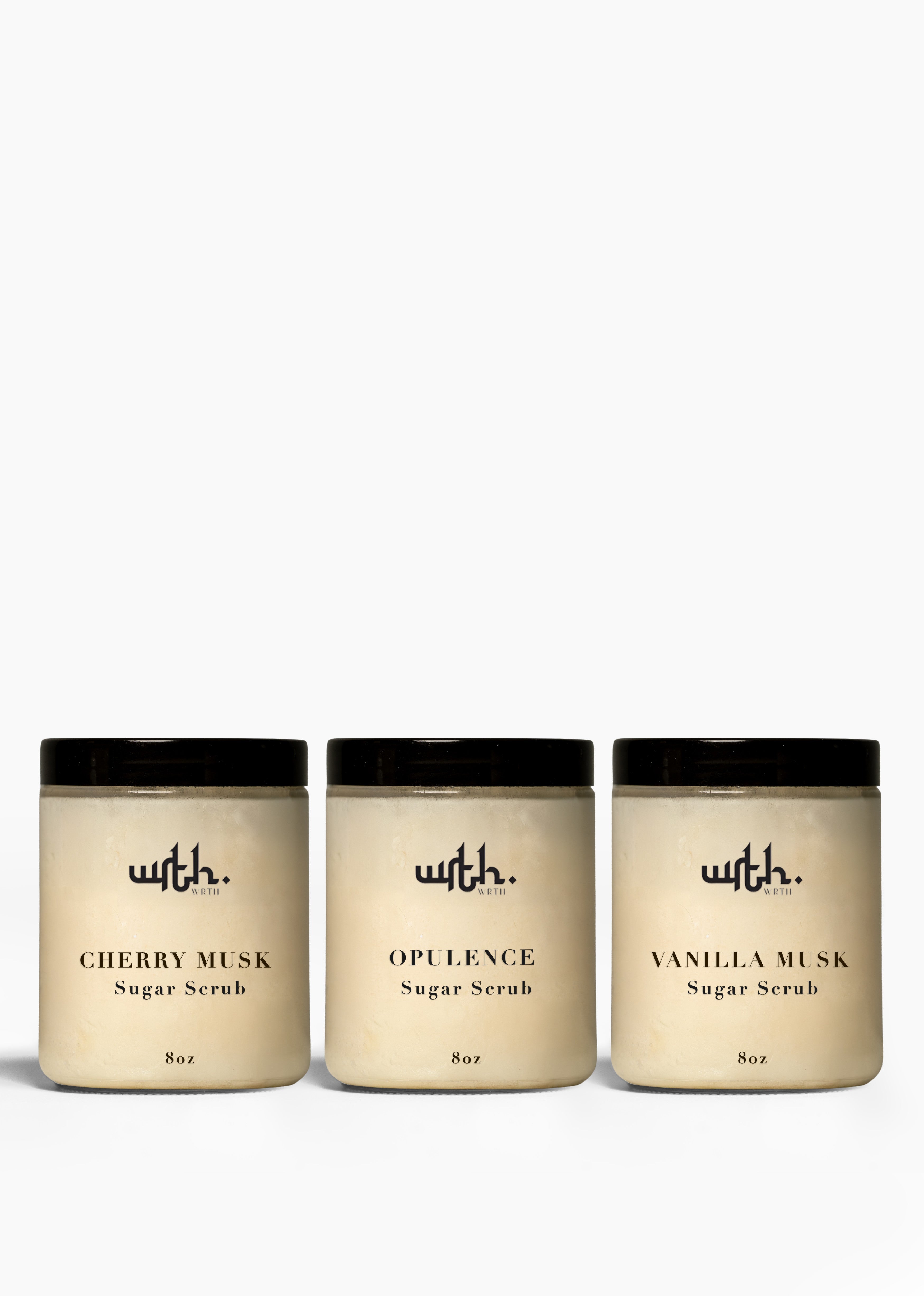 Three jars of sugar scrub with black lids on a white background