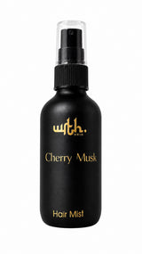 Black hair mist bottle labeled 'Cherry Musk' with gold text on a white background