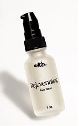 Bottle of rejuvenating face serum with a black pump on a white background
