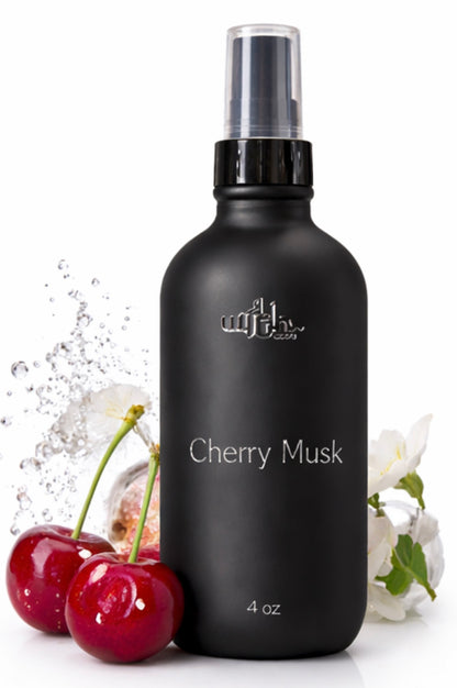 Black bottle of 'Cherry Musk' with cherries and flowers on a white background