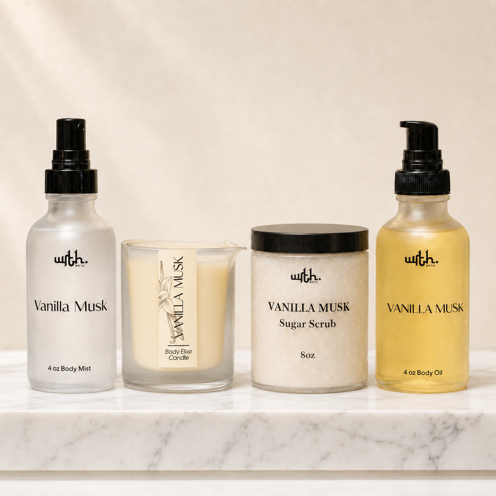 Four vanilla musk body care products from 'wrth.' arranged on a white marble surface against a warm beige background: a body mist spray, a body wick candle, a sugar scrub jar, and a body oil bottle.
