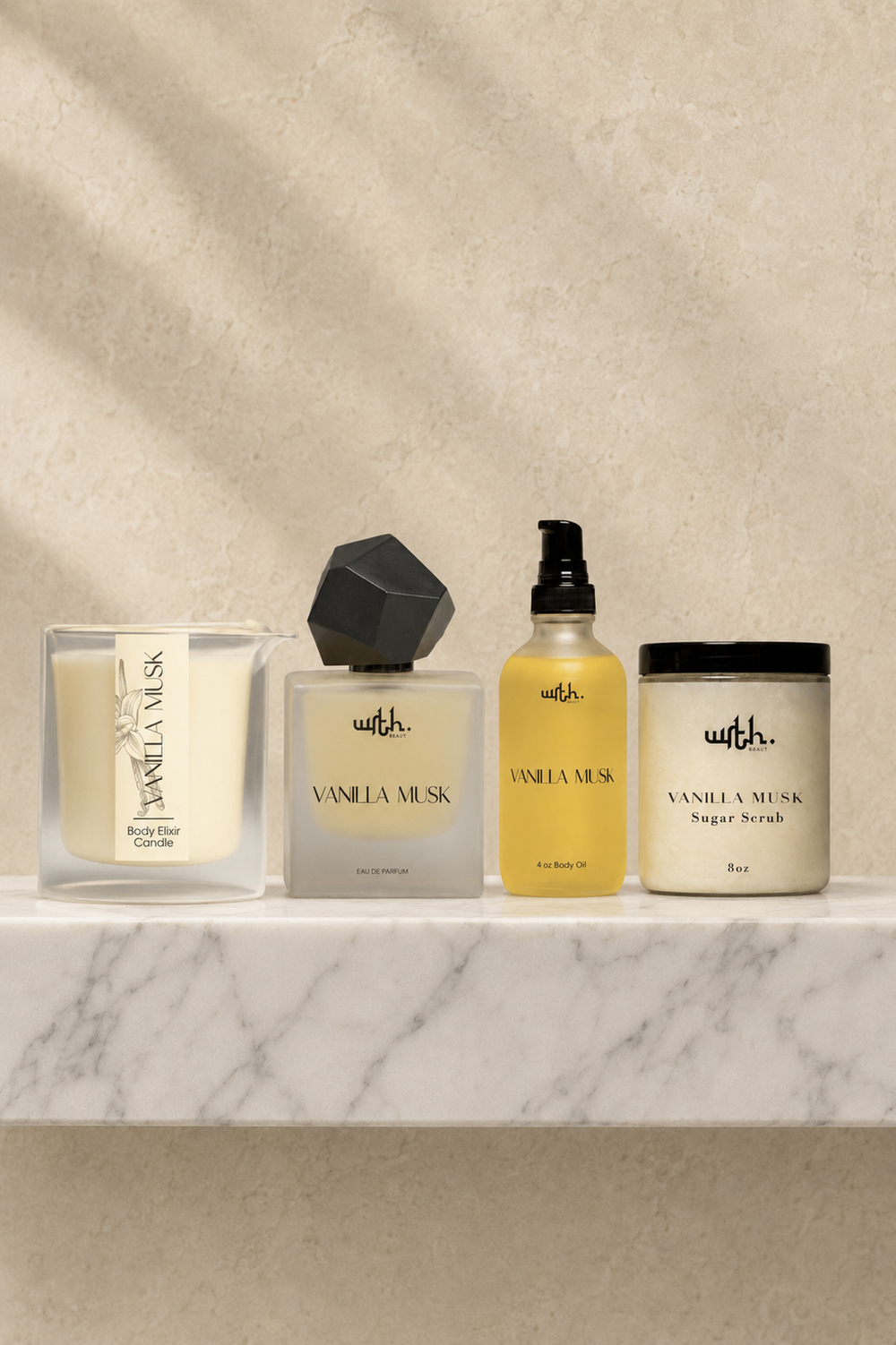 Four bath and body products from the brand 'wrth.' arranged on a white marble shelf against a textured beige wall with soft leaf shadows.