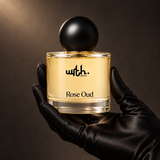 Black satin-gloved hand holding WRTH Rose Oud Eau de Parfum