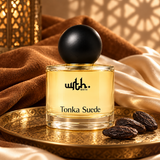 WRTH Tonka Suede Eau de Parfum on an ornate gold tray with tonka beans and draped brown and cream fabric