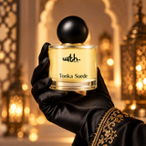 Black satin-gloved hand holding WRTH Tonka Suede Eau de Parfum