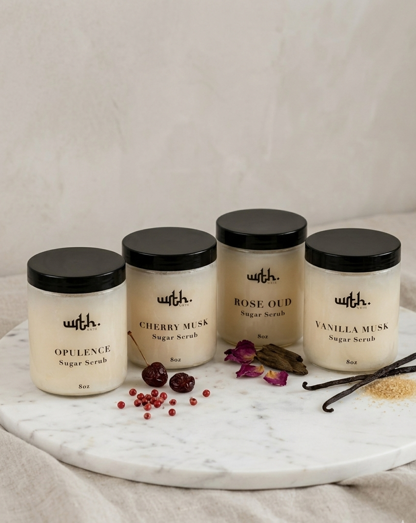 Four jars of 'with.' body scrubs on a marble tray with decorative elements.