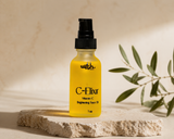 Yellow bottle labeled 'C-Elixir' on a stone surface with a natural background