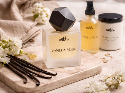 Vanilla Musk perfume bottle with vanilla beans and flowers on a marble surface