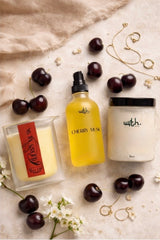 Three scented products with cherry musk fragrance on a light surface with cherries and flowers.
