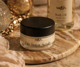 Jar of lip sugar scrub with a black lid on a marble surface, with 'with.' branding.