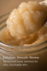 Jar of exfoliating scrub with a spoonful above, labeled 'Exfoliate. Smooth. Renew.'