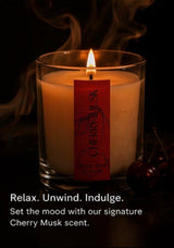 Candle with a Cherry Musk label on a dark background