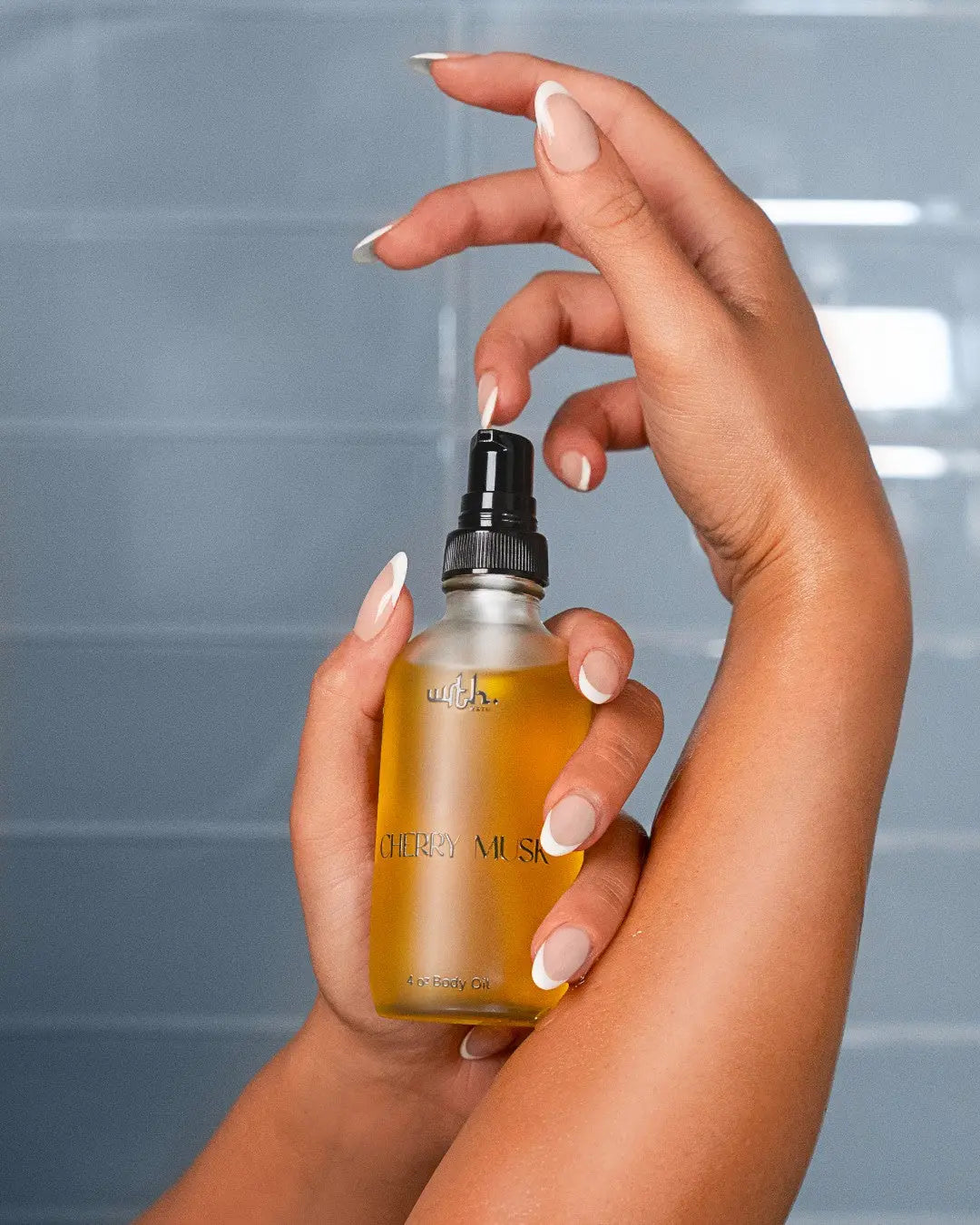 Hand holding a bottle of oil with a blurred background