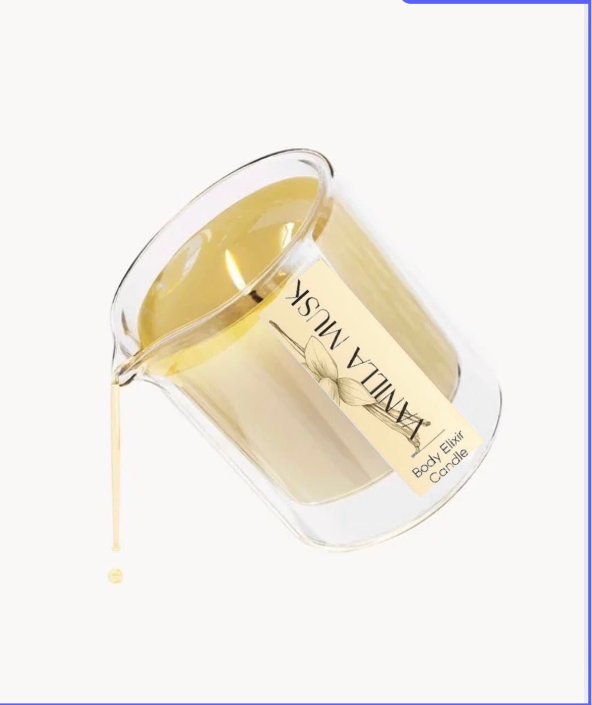 Clear glass beaker pouring warm vanilla musk body elixir candle oil with beige label